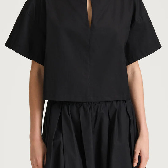 Black top and skirt set on a plain background from Stylein
