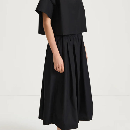 Person wearing a black outfit on a white background from Stylein