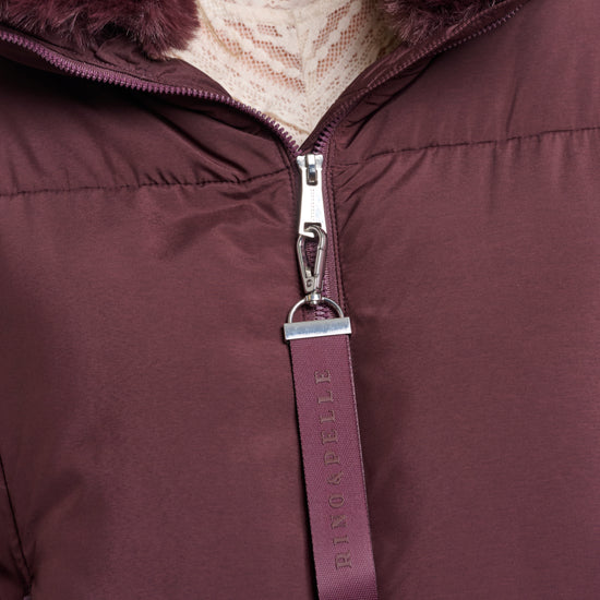 Close-up of a purple puffer jacket with fur hood and zipper detail.