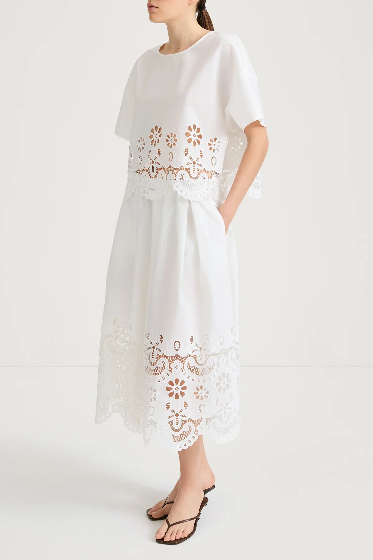 White dress with lace details on a white background
