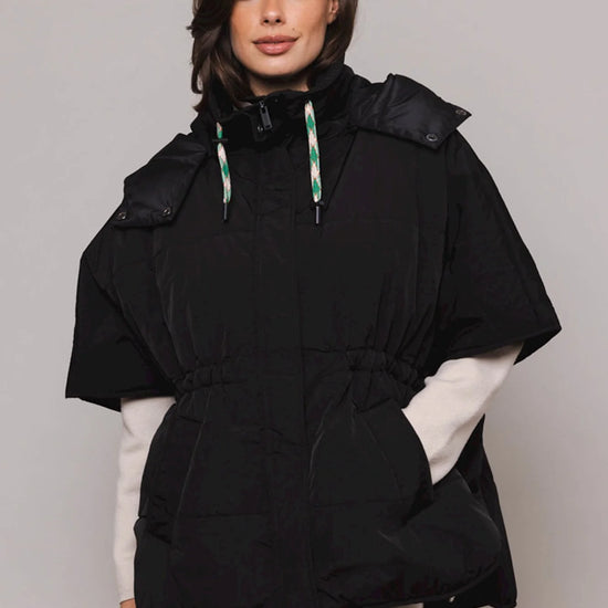 Black shower proof cape with detachable hood and drawstring fastenings sleeveless with two front slant pockets