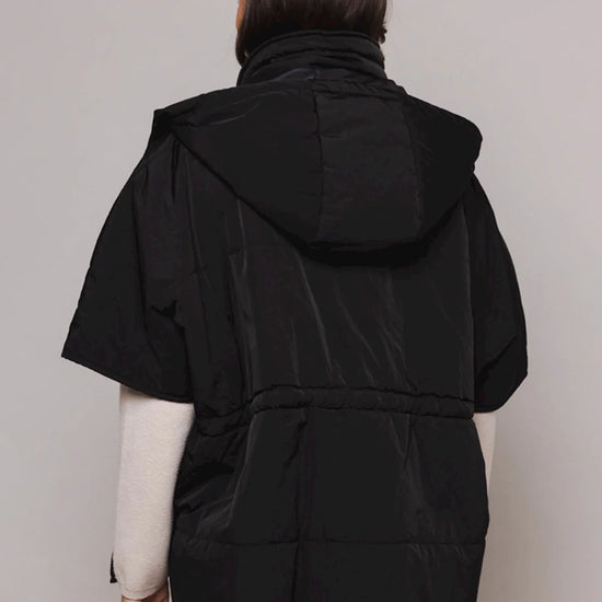 Black shower proof cape with detachable hood and drawstring fastenings sleeveless with two front slant pockets