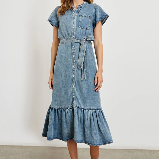 Woman wearing a denim dress with a white background