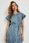 Woman wearing a denim dress against a white background