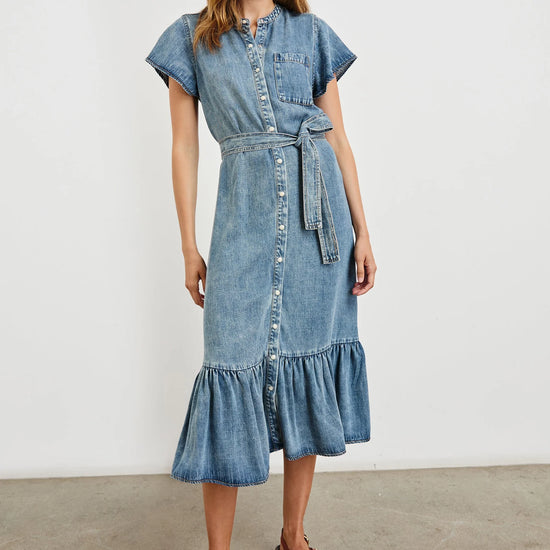Woman wearing a denim dress with a white background