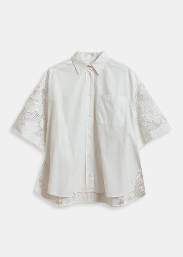 White blouse with lace sleeves on a white background