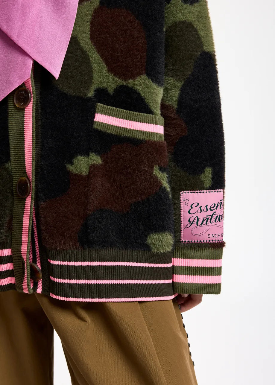 Close-up of a fuzzy camouflage cardigan with pink striped trim and a pink brand patch 