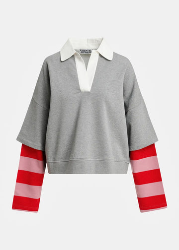 A gray knit rugby-style pullover sweater with a white collar and red-and-pink striped sleeves, shown on a light gray background.