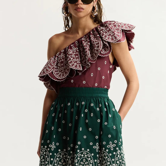 model wearing green skirt on plain background