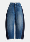A pair of wide-leg blue denim jeans with contrasting dark navy side panels, shown against a plain light gray background.