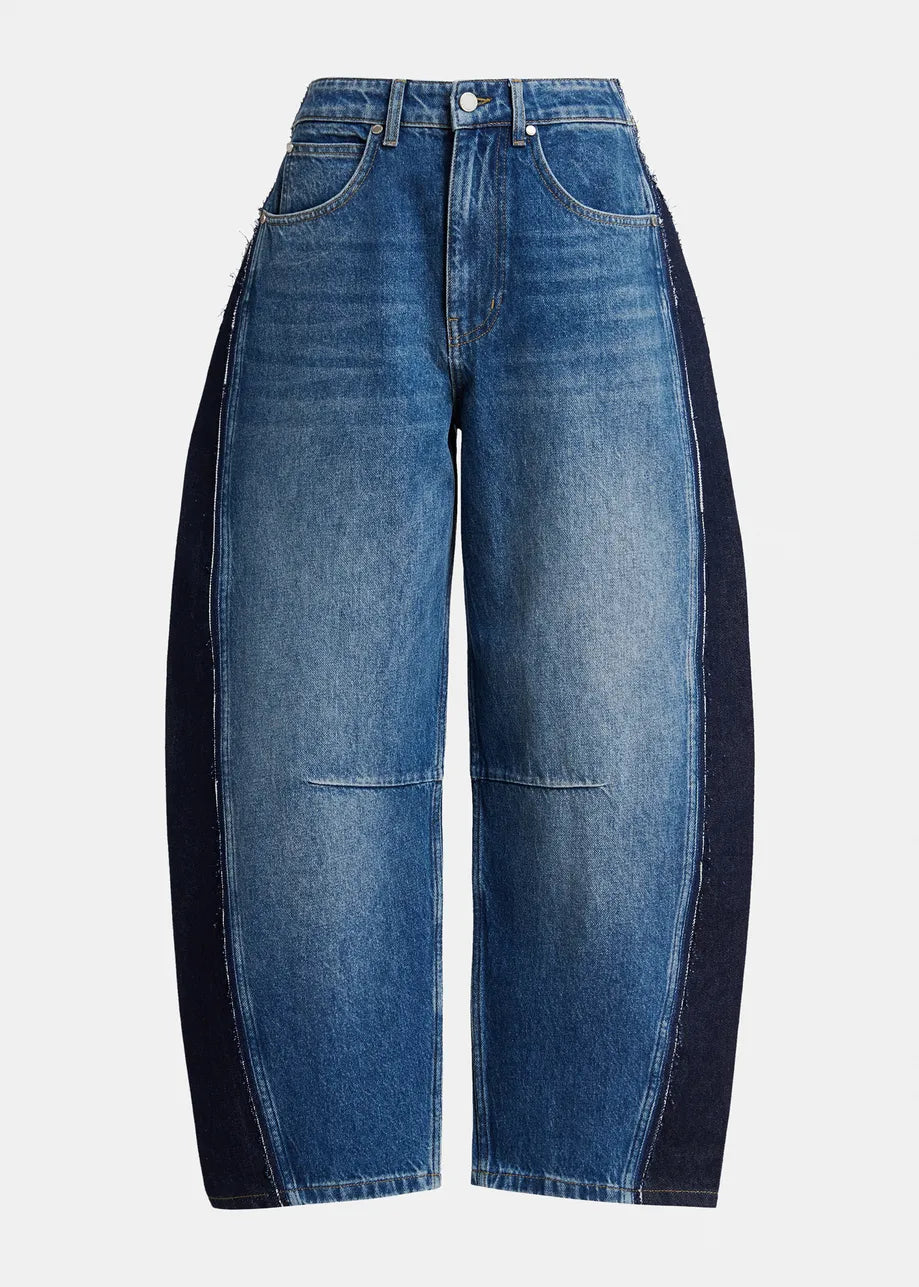 A pair of wide-leg blue denim jeans with contrasting dark navy side panels, shown against a plain light gray background.