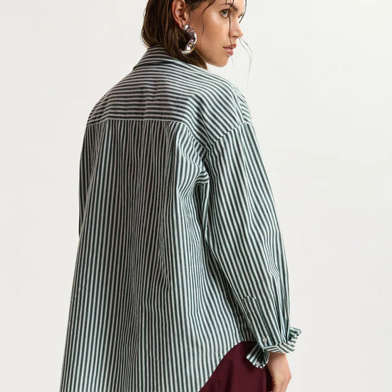 model wearing green stripe shirt shot from the rear