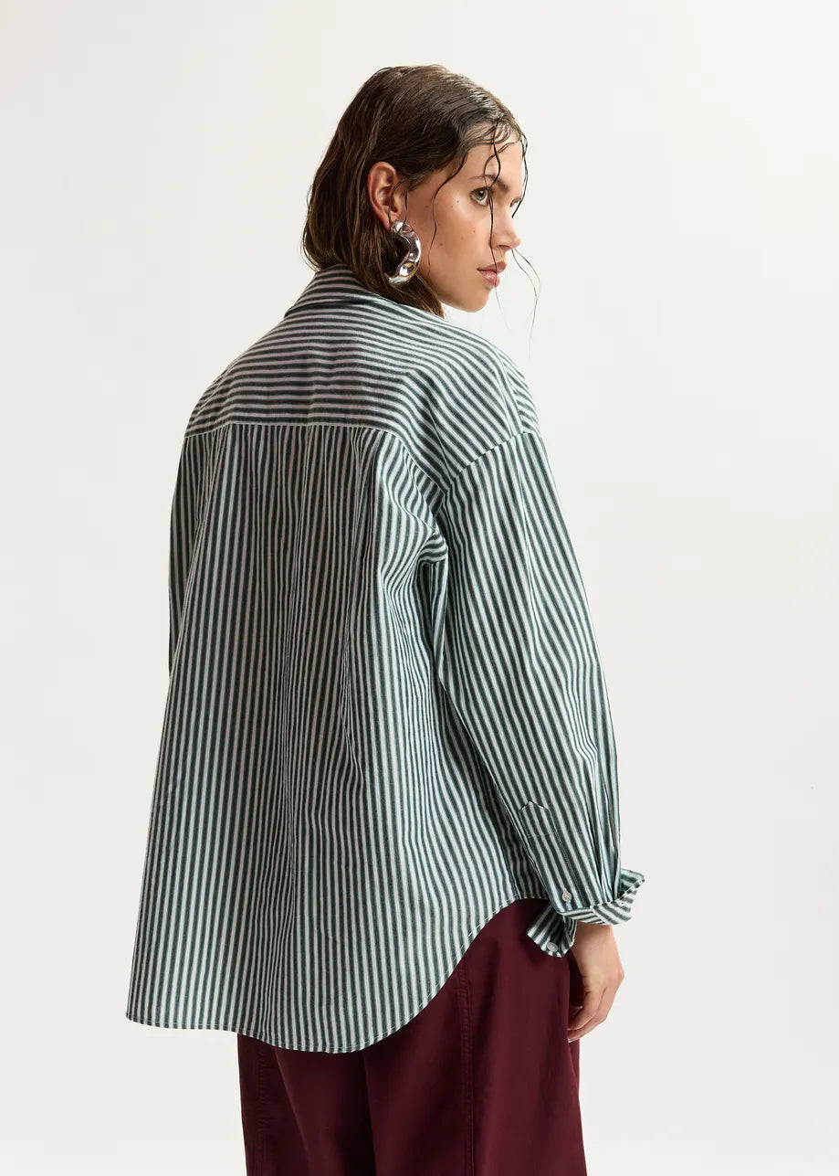 model wearing green stripe shirt shot from the rear