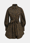 A leopard print shirt dress in brown and black, featuring a collar, button front, flap chest pockets, and a matching waist tie, shown against a light gray background.