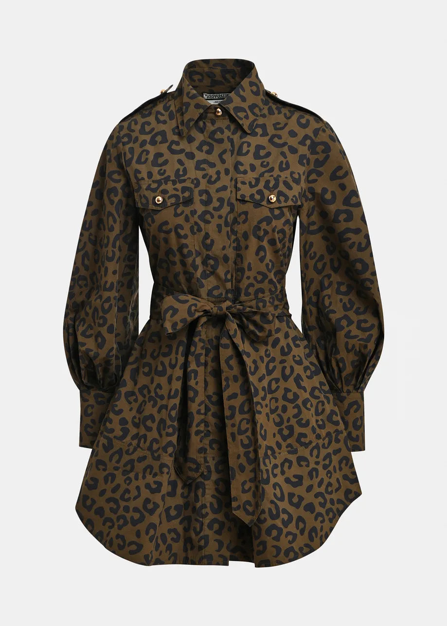 A leopard print shirt dress in brown and black, featuring a collar, button front, flap chest pockets, and a matching waist tie, shown against a light gray background.