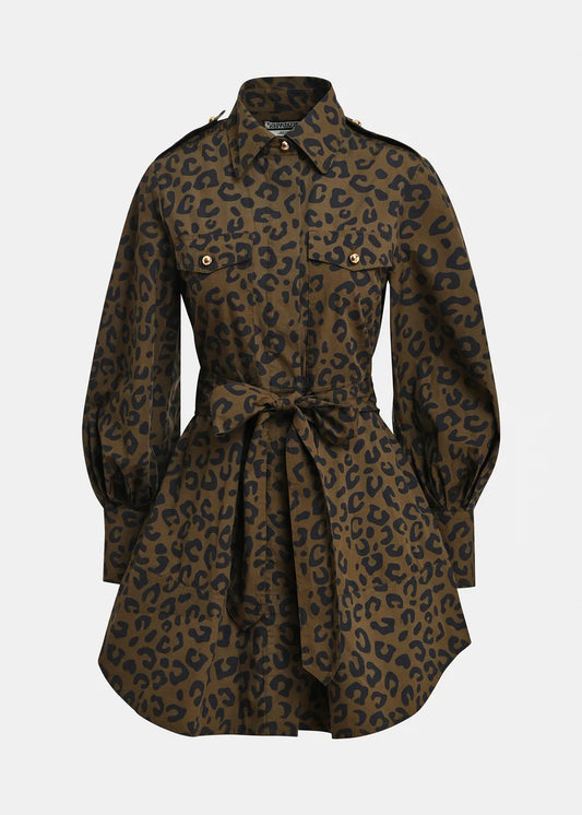 A leopard print shirt dress in brown and black, featuring a collar, button front, flap chest pockets, and a matching waist tie, shown against a light gray background.