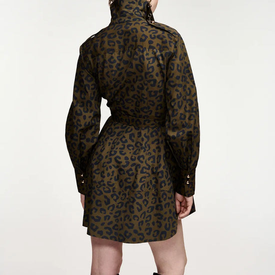A model shown from the back wearing a leopard-print mini coat with a high collar and black knee-high boots, set against a plain light gray studio background.