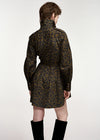 A model shown from the back wearing a leopard-print mini coat with a high collar and black knee-high boots, set against a plain light gray studio background.