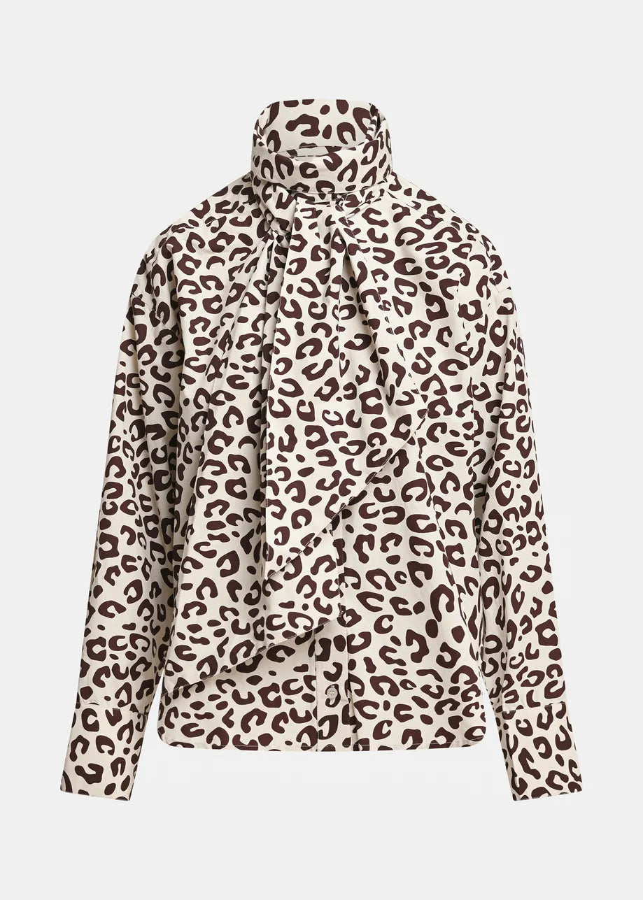 A long-sleeve blouse with a high mock neck and a large front bow, featuring a brown leopard print pattern on a cream background.