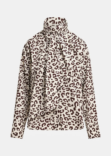 A long-sleeve blouse with a high mock neck and a large front bow, featuring a brown leopard print pattern on a cream background.