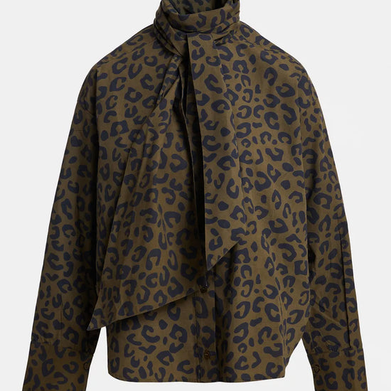 A leopard print wrap jacket with a high draped collar and tie-front detail, shown on a neutral light gray background.