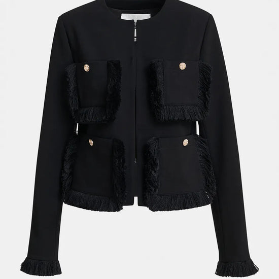 A black cropped jacket with fringed trim details and gold-tone button accents, shown against a plain light gray background.