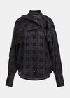 A black and gray plaid button-down shirt with an asymmetrical draped collar and long sleeves, shown against a light gray background.