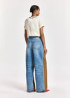 woman wearing White tshirt with a chain and brown trousers on  a white background rear view
