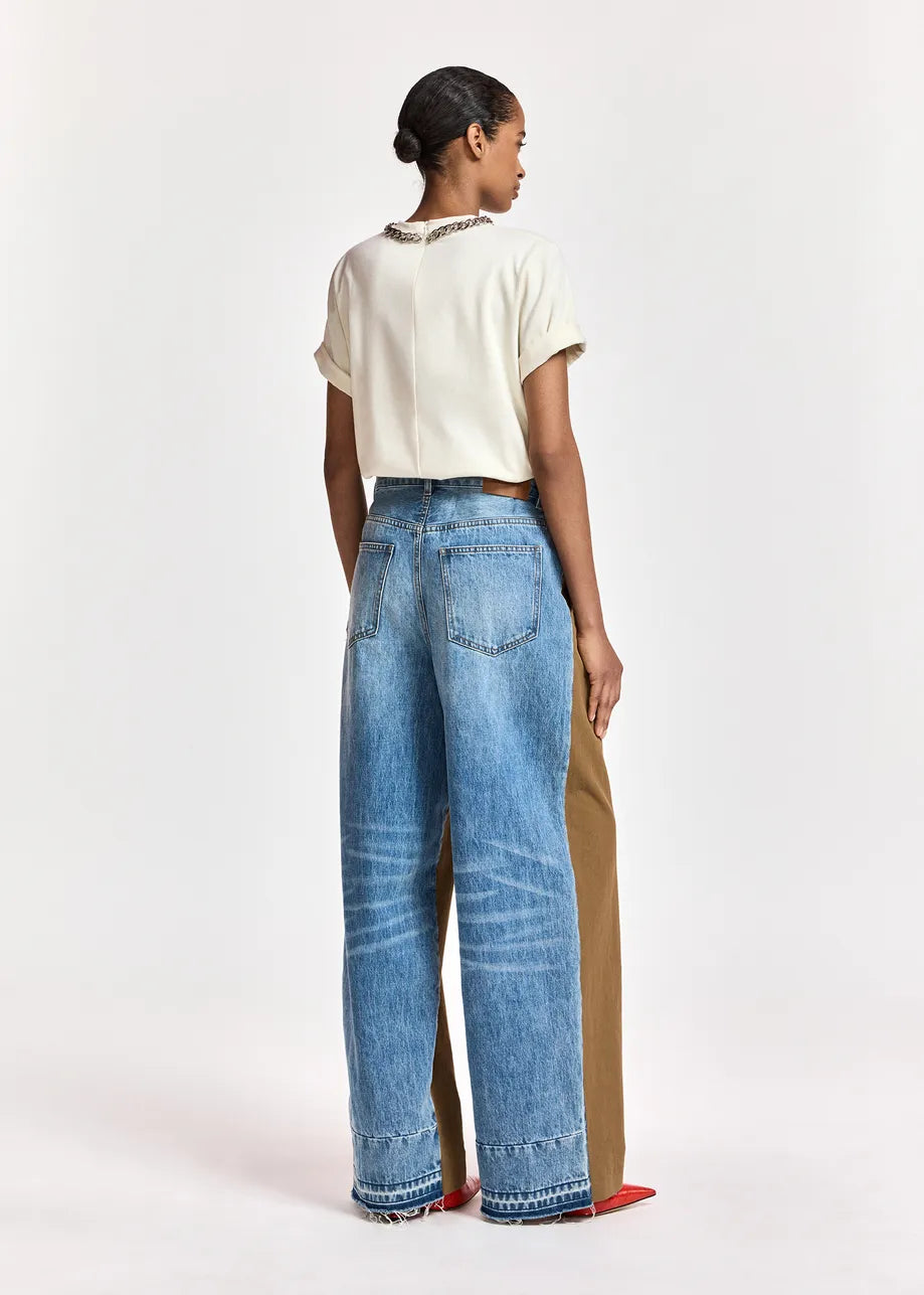 woman wearing White tshirt with a chain and brown trousers on  a white background rear view