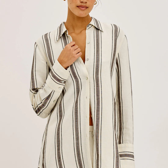 Woman wearing a striped shirt and shorts set on a white background