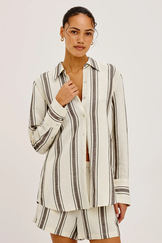 Woman wearing a striped shirt and shorts set on a white background