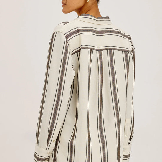 model wearing brown and cream stripe shirt
