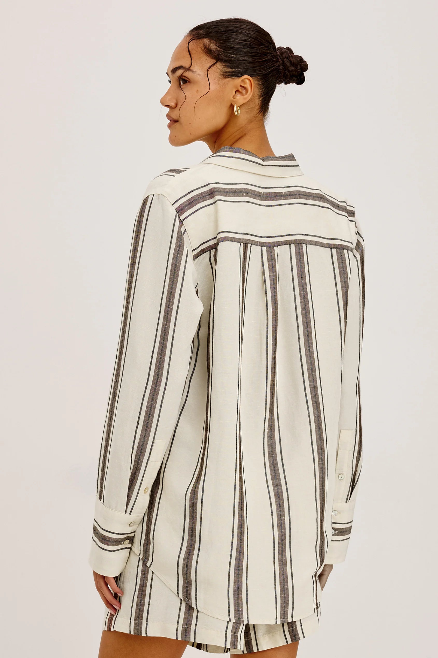 model wearing brown and cream stripe shirt