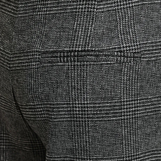 Close-up of dark gray and black plaid trousers showing the fabric texture and a side pocket.