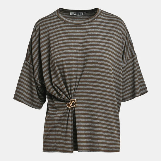 A striped short-sleeve top with a gathered front detail and a gold-tone ring accent, shown against a plain light gray background.