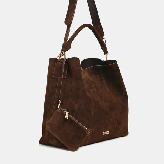 A dark brown suede tote bag with a matching zippered pouch and a shoulder strap, shown against a light gray background.