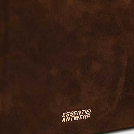 Close-up of a dark brown suede or faux-suede material surface with the white 'ESSENTIEL ANTWERP' logo printed near the bottom.