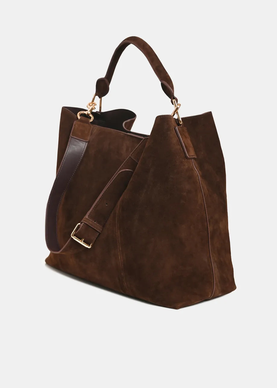 A dark brown suede tote bag with a matching brown leather shoulder strap and gold-tone hardware, shown on a light gray background.