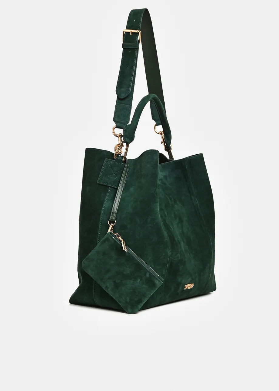A dark green suede tote bag with a matching detachable shoulder strap and a small matching pouch, featuring gold-tone hardware on a light gray background.