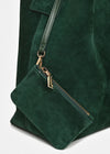 Close-up of a dark green suede tote bag with a matching shoulder strap and a small zippered pouch attached by gold-tone hardware.