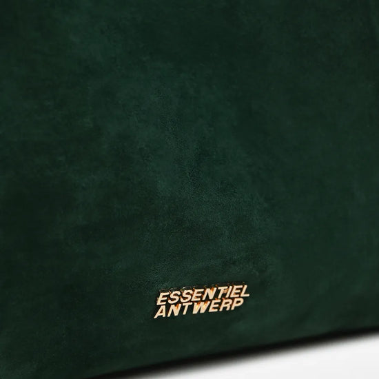 Close-up of a dark green suede or velvet bag surface with the gold-toned 'ESSENTIEL ANTWERP' logo near the bottom.