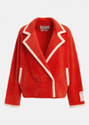 A bright red sherpa fleece blazer jacket with contrasting cream-colored piping and trim, shown against a plain light gray background. The brand 'ESSENTIALS' is visible on the inner neck label.