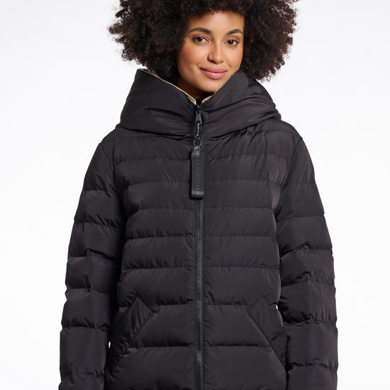 reversible black mid length padded coat with a brown interior, high neck and collar model shot