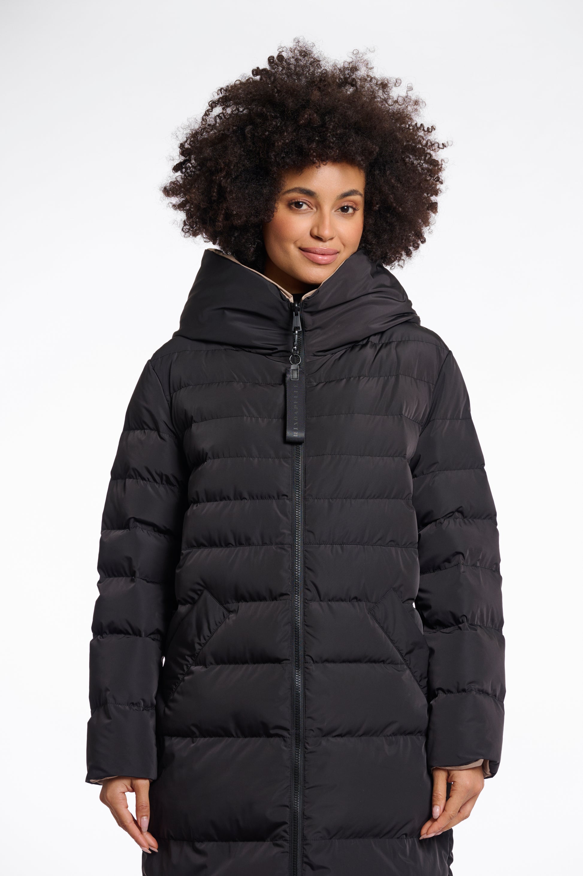 reversible black mid length padded coat with a brown interior, high neck and collar model shot