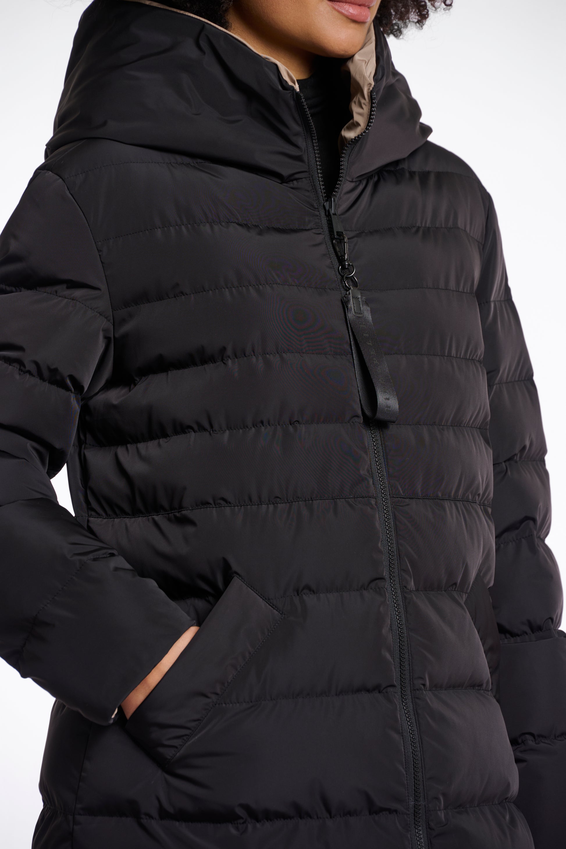 reversible black mid length padded coat with a brown interior, high neck and collar close up