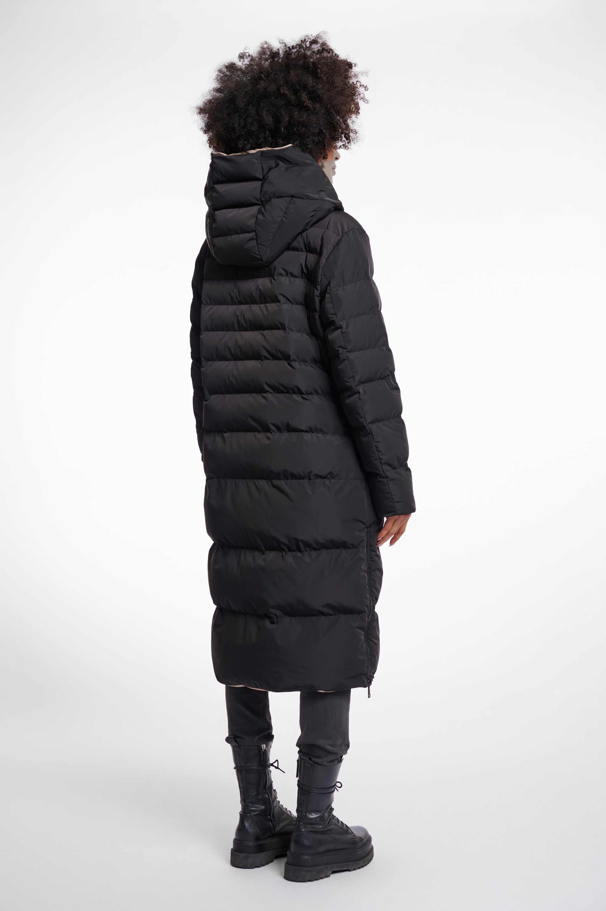 reversible black mid length padded coat with a brown interior, high neck and collar rear view 