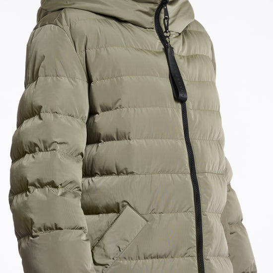 green mid length added reversible coat with matt green exterior, large hod and side pockets side view