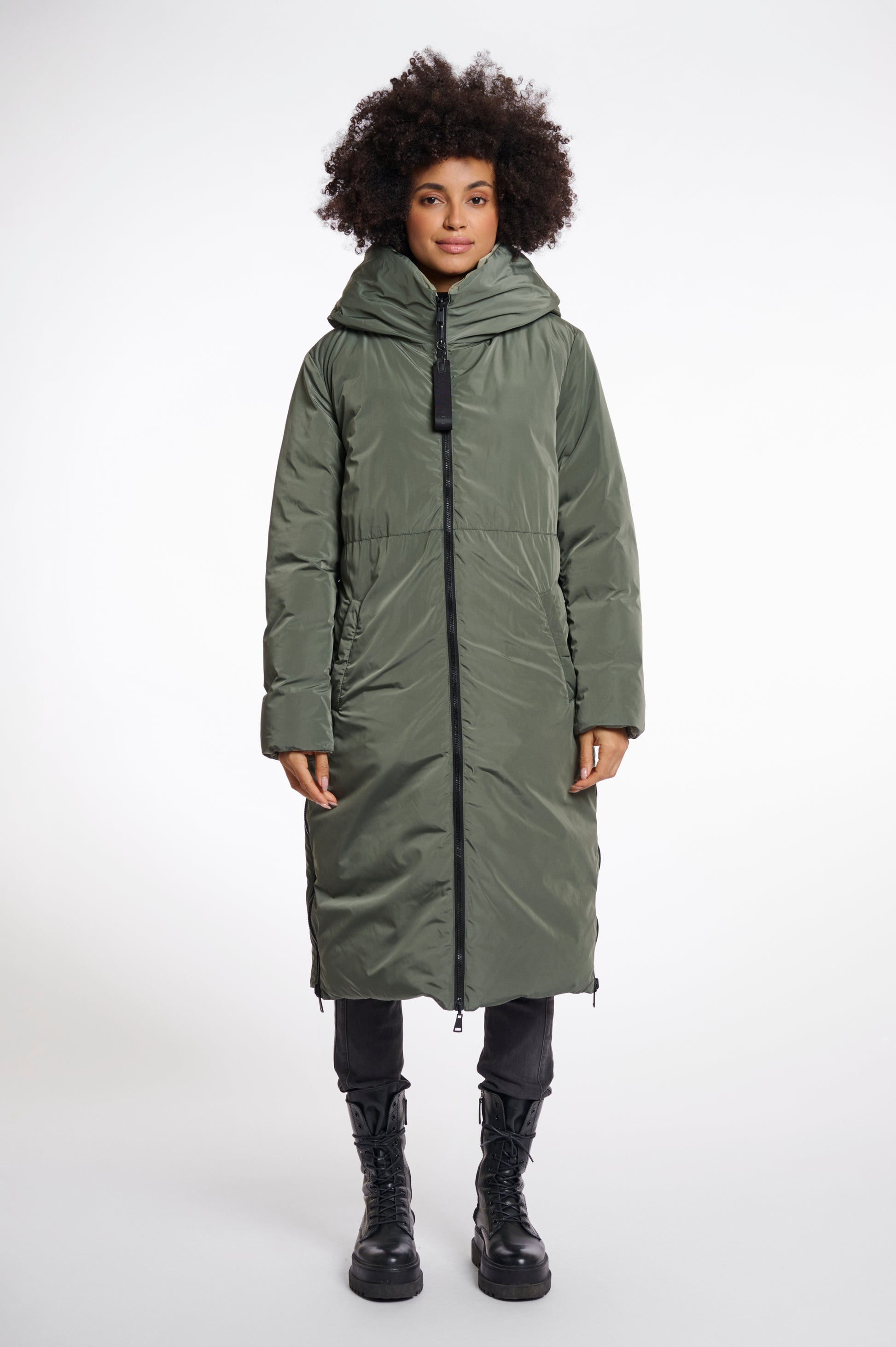 green mid length added reversible coat with matt green exterior, large hod and side pockets interior shot