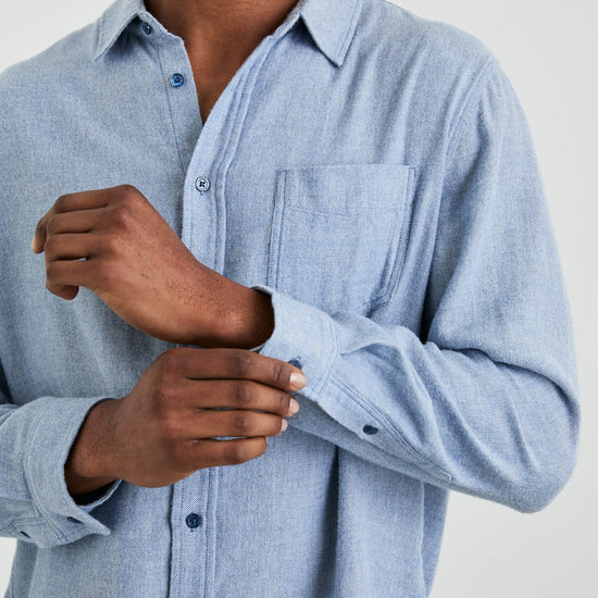 mens blue shirt with chest pocket and curved hem close up