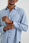 mens blue shirt with chest pocket and curved hem close up